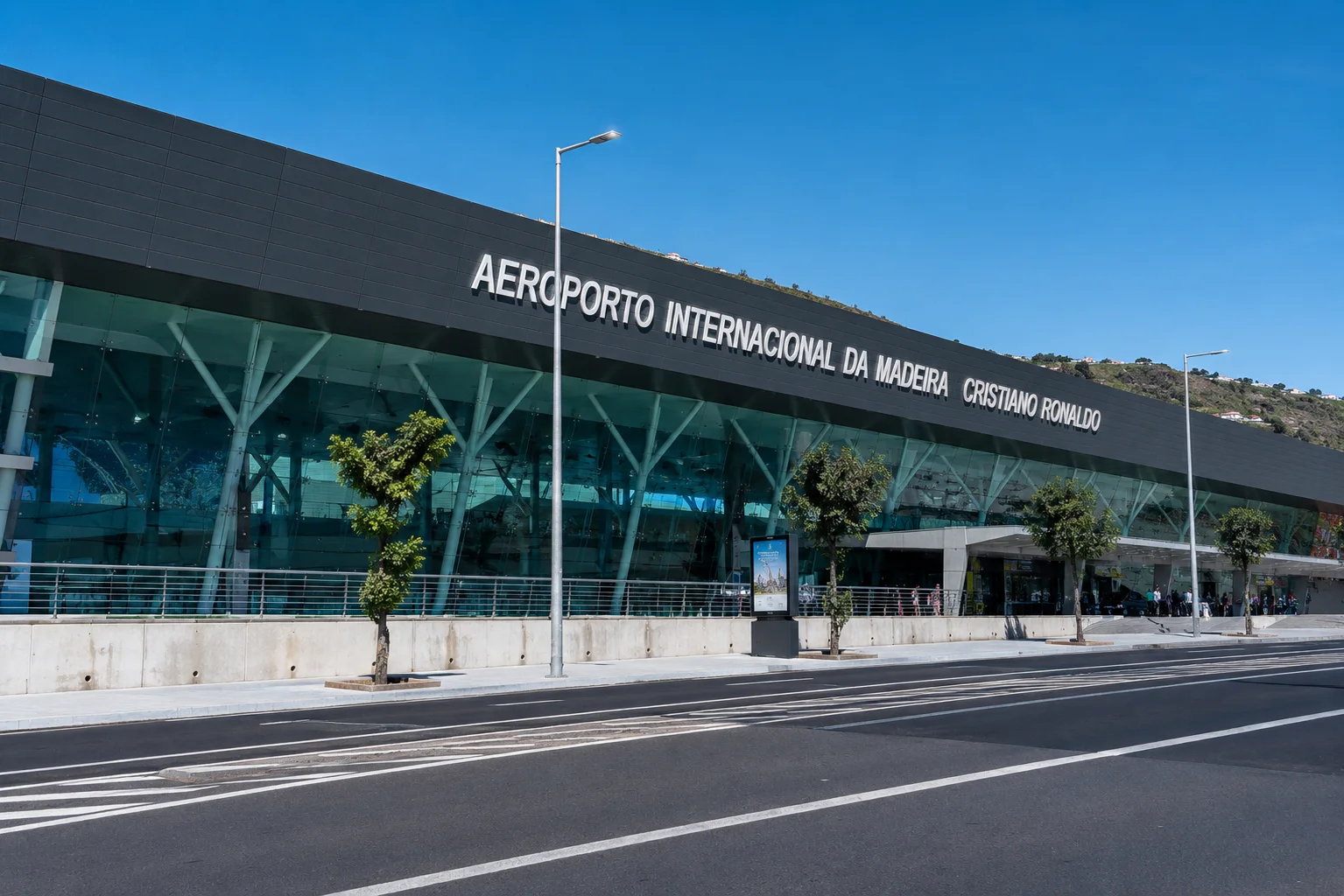 A travel and lifestyle infographic celebrating the naming of the Cristiano Ronaldo International Airport in his birthplace of Madeira. The left side displays a scenic view of an airplane descending over the coast of Funchal, paired with an insert photo of the famous bronze bust of Ronaldo displayed at the terminal entrance. The right side details the regional government's decision to rename the airport in 2016 following Portugal's European Championship triumph, honoring him as Madeira's greatest global ambassador.