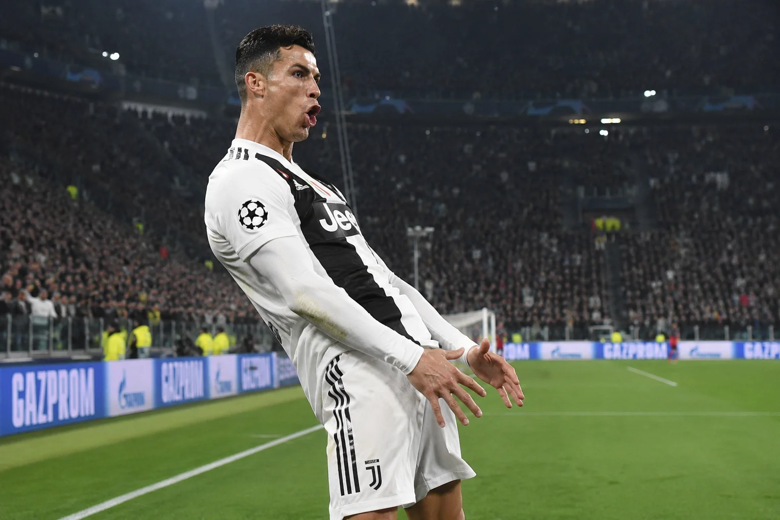 An infographic detailing Cristiano Ronaldo's multi-year spell in Italy with Juventus. On the left, a focused Ronaldo is captured looking forward in the iconic black-and-white vertically striped Juventus jersey featuring the Jeep sponsor logo. The background is stylized with architectural elements of the Allianz Stadium in Turin. On the right, a breakdown details his impact from 2018 to 2021, showcasing his back-to-back Serie A titles, domestic cup triumphs, and his achievement of reaching 100 club goals faster than any player in Juventus history.