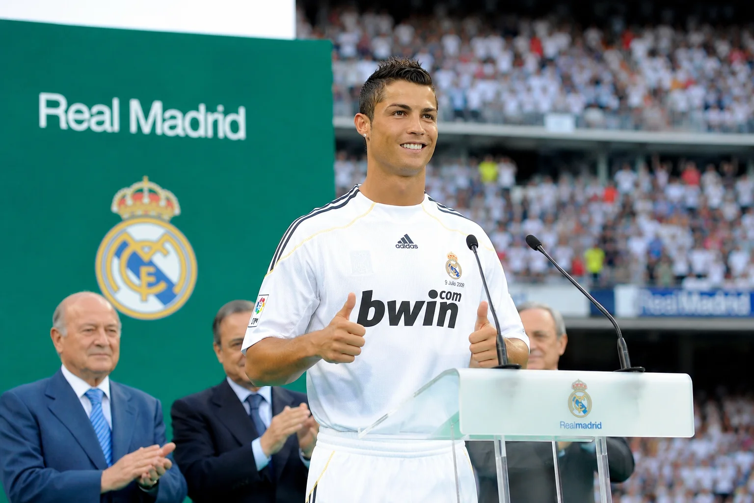 A high-contrast career infographic focusing on Cristiano Ronaldo's historic era at Real Madrid. The left panel shows Ronaldo in a powerful stance wearing the clean white Real Madrid home kit with a Fly Emirates sponsor logo, set against a glowing blue geometric rendering of the Santiago Bernabéu Stadium. The right panel outlines his astronomical statistics from 2009 to 2018, explicitly breaking down his 450 goals in 438 games, four Champions League titles, and four additional Ballon d'Or awards.