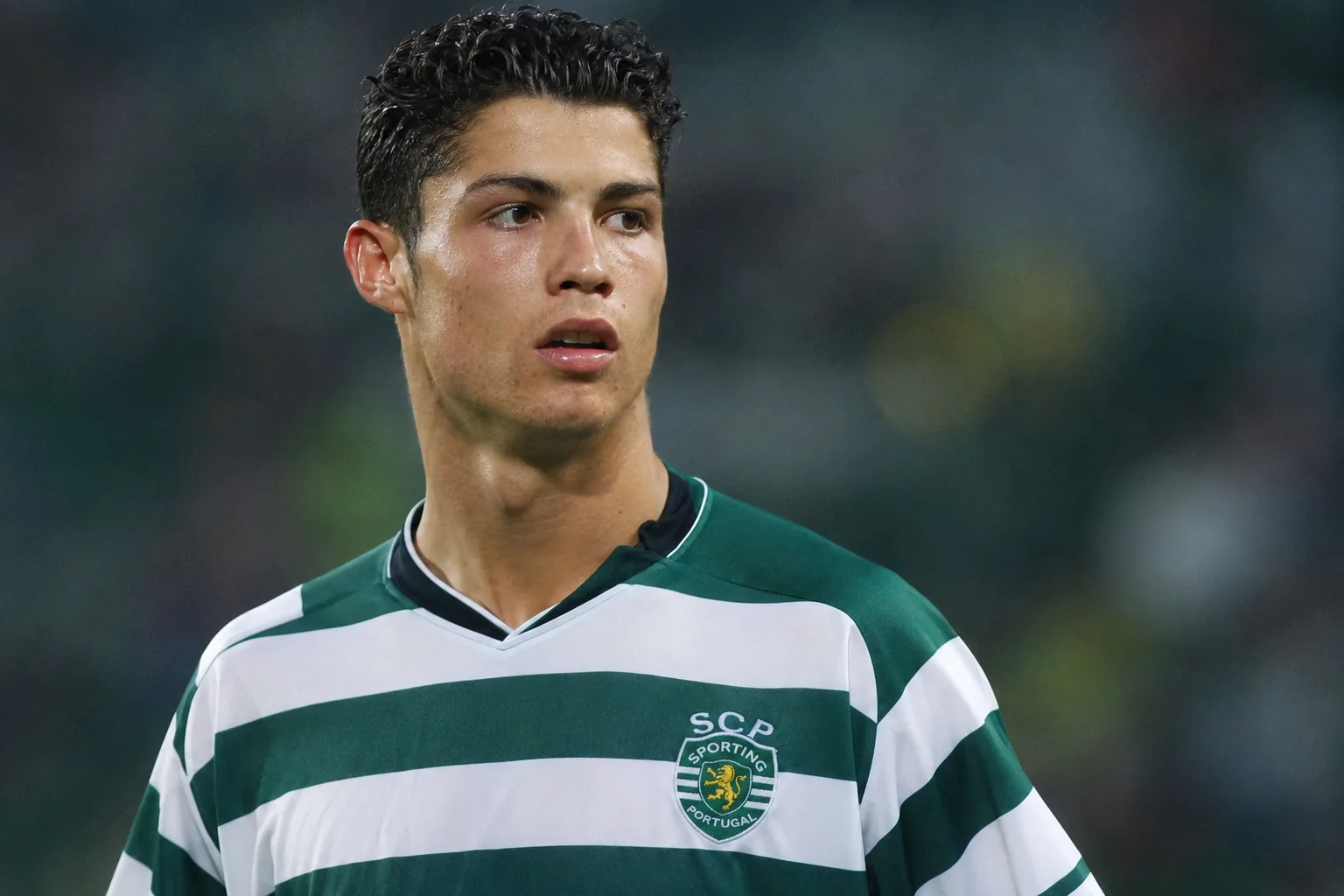 An infographic illustrating Cristiano Ronaldo's career beginnings at Sporting CP. On the left, a teenage Ronaldo looks onward in the green-and-white horizontally striped Sporting CP home kit. The background elements include a faint graphic of the club's lion crest and structural lines of the Estádio José Alvalade. On the right, clean textual summaries detail his breakthrough year in the 2002-2003 season, his iconic performance in a pre-season friendly against Manchester United, and his subsequent transfer to England.