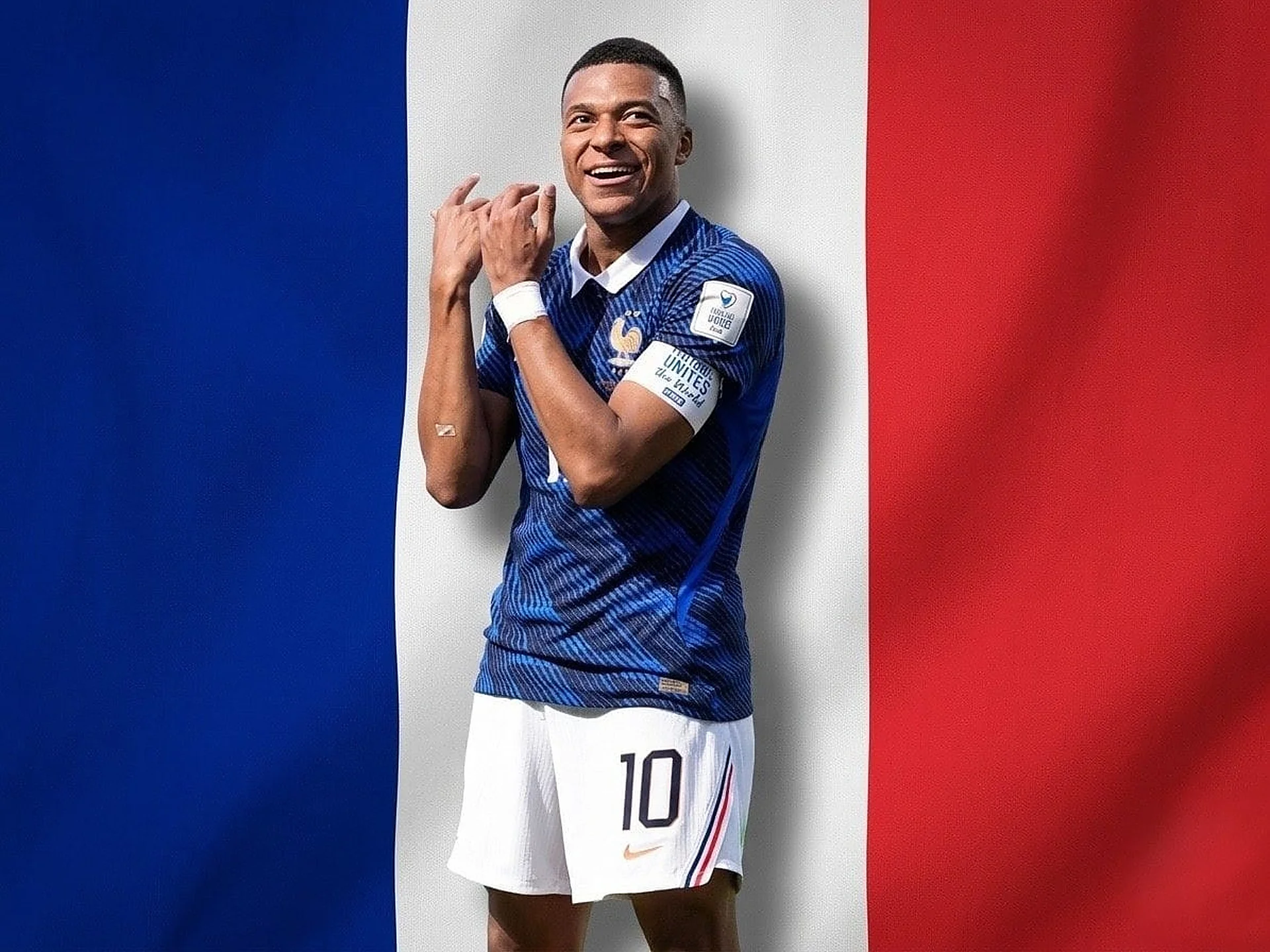 Features French forward Kylian Mbappé smiling in front of the French tricolor flag.