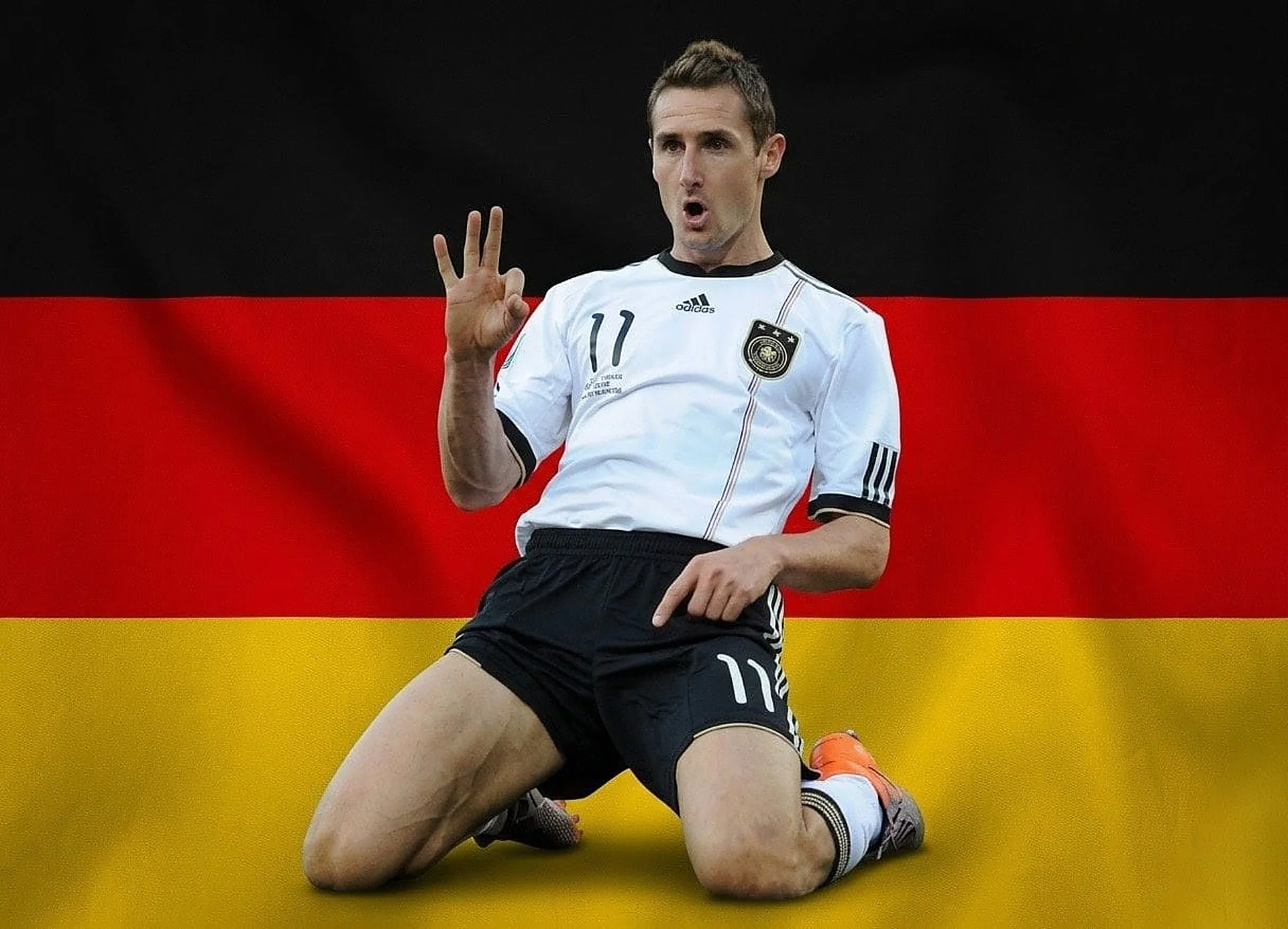 Shows Germany's all-time World Cup top scorer Miroslav Klose performing his famous knee-slide celebration.