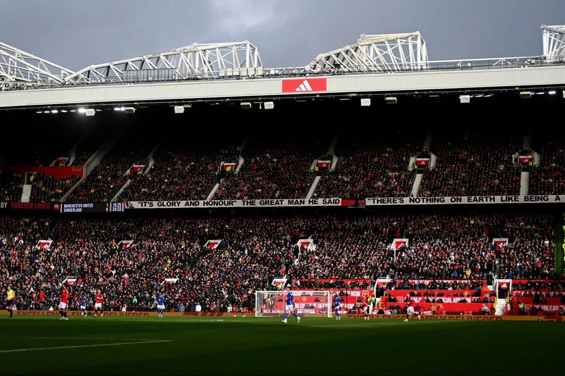 Old Trafford matchday crowd inside the stadium with Manchester United supporters filling the stands during a home fixture.