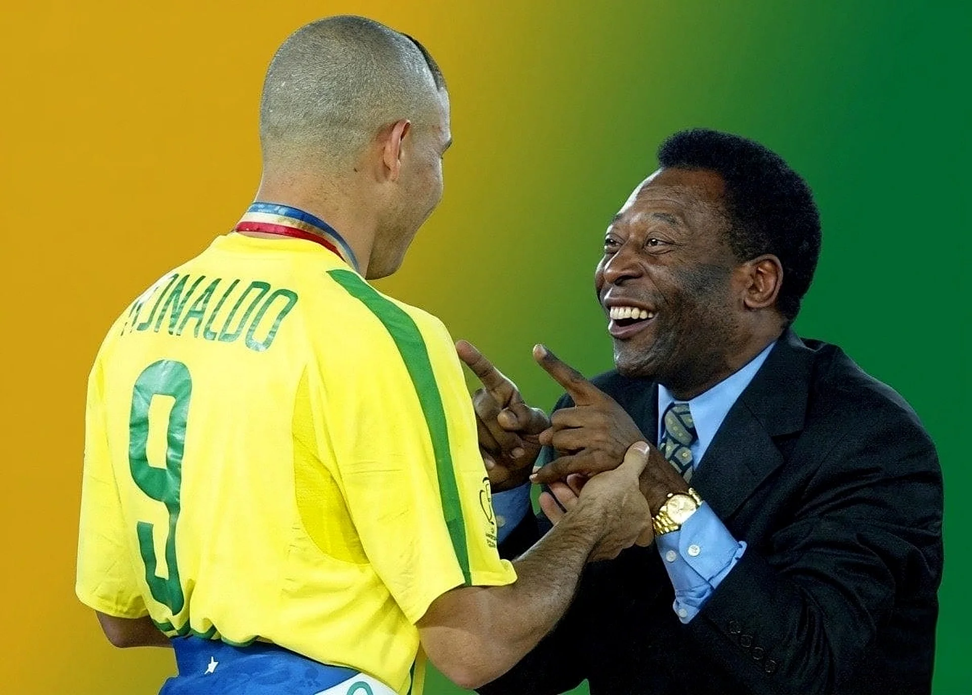 Captures a legendary Brazilian moment showing Ronaldo Nazário (with his back turned wearing the number 9) sharing a joyful laugh with the king of football, Pelé.