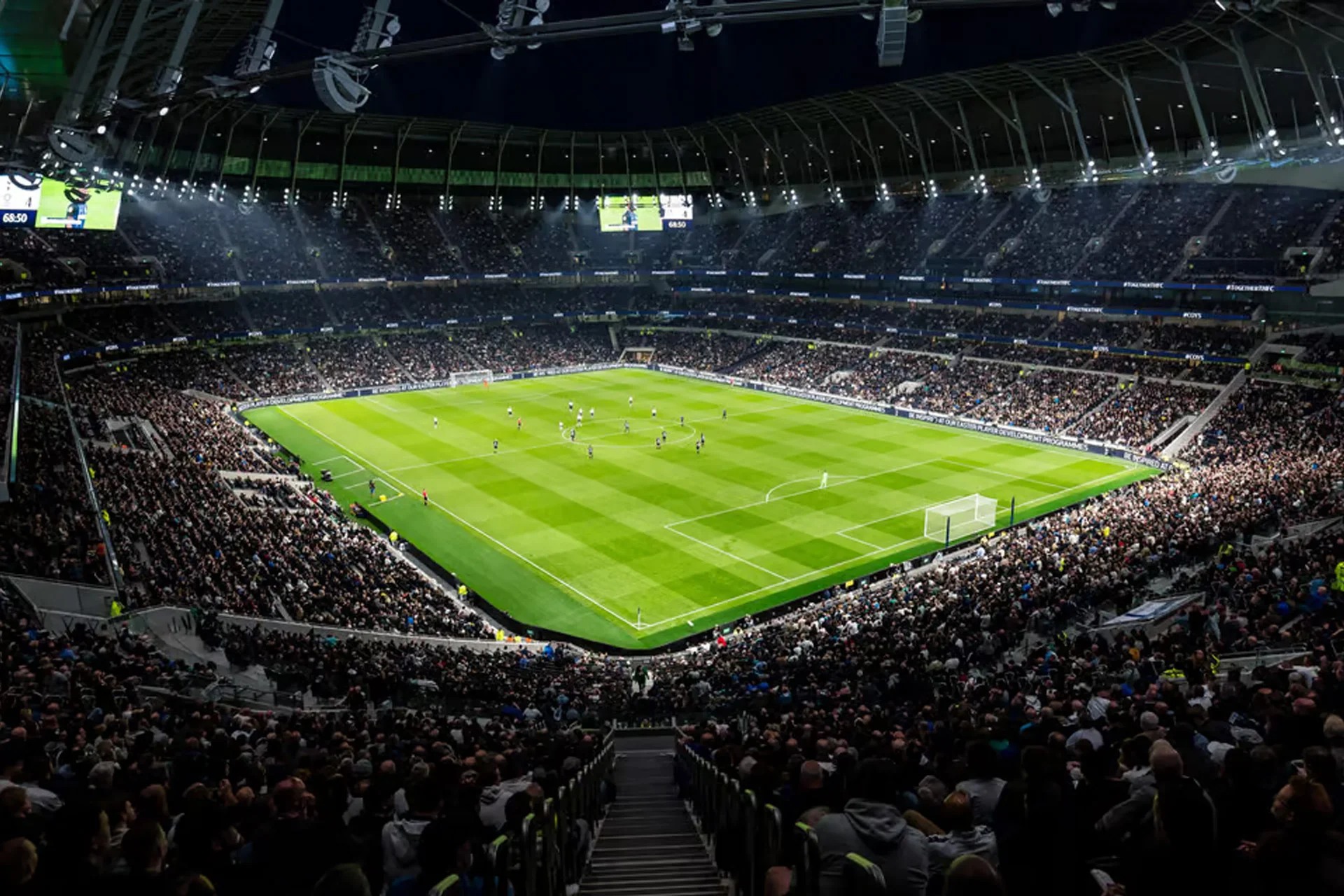 Inside Tottenham Hotspur Stadium during a matchday fixture with fans seated around the pitch.